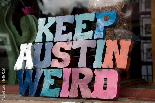 Colorful plate with word Austin in front of a shop window