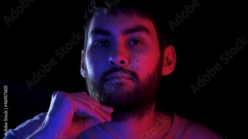 Portrait handsome man combing beard colorful neon led light. Fashion hipster prepare shave ultraviolet illuminance. Led lighting unshaven guy. Bearded people shaving neon illumination in ultra violet.