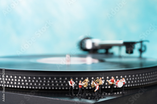 Miniature brass band, turntable and blue background