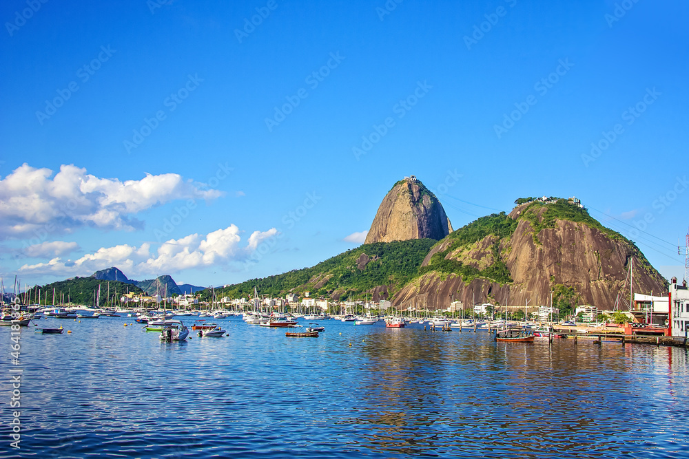 Berth, port with boats, shallops and Urku mountains and Sugar Loaf. Guanabara Bay, a creek on the shores of the Atlantic Ocean. Brasilia, Rio de Janeiro