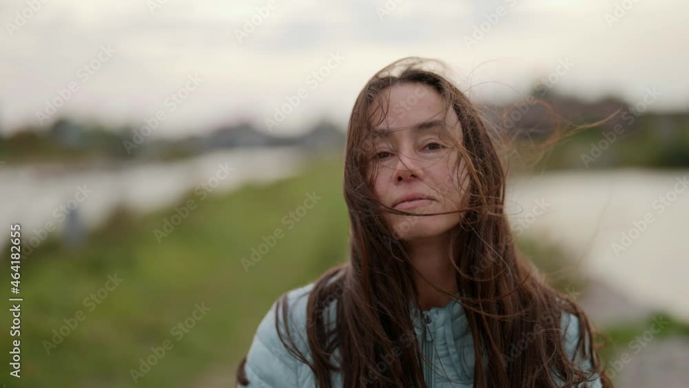 An adult beautiful brunette is spinning on a walk in windy weather. An attractive age model with flowing hair. An adult beautiful brunette is spinning on a walk in windy weather. An attractive age model with flowing hair.