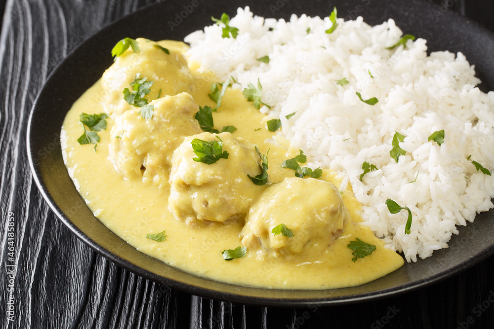 Meatballs in Curry Sauce with rice close up in the plate on the table. horizontal Meatballs in Curry Sauce with rice close up in the plate on the table. horizontal