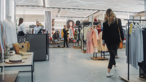 Clothing Store: Diverse Group of Costumers Shopping, bying Clothes and Merchandise at Checkout Cashier Counter. Retail Fashion Shop Assistant Helps Clients, Selling Stylish Designer Brands. photo