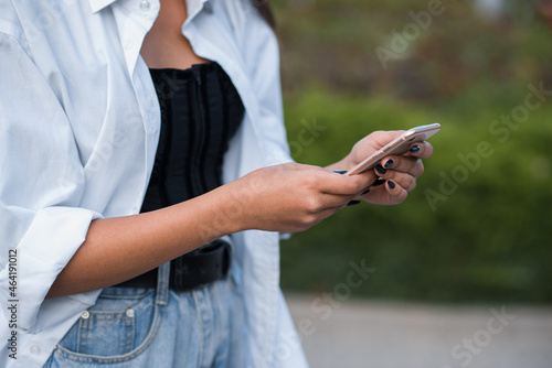 Close up of female hands using a smartphone.