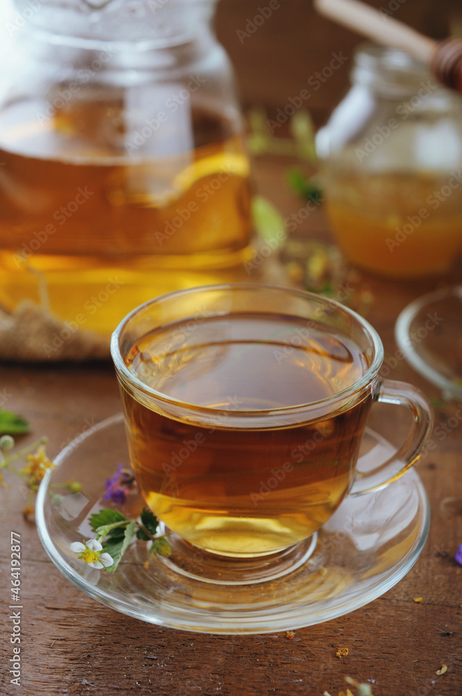 Hot herbal tea with chamomile and honey on wooden background Hot herbal tea with chamomile and honey on wooden background