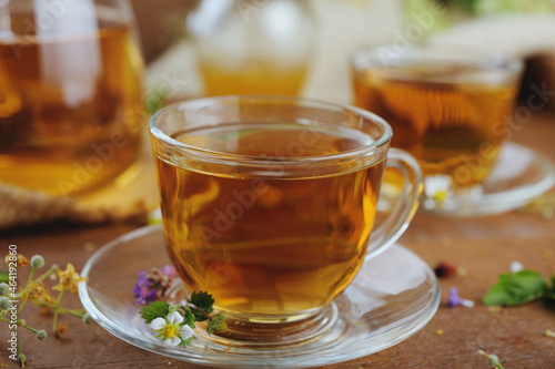 Hot herbal tea with chamomile and honey on wooden background 