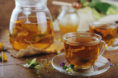 Hot herbal tea with chamomile and honey on wooden background 