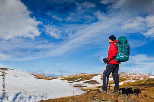 Hiking man in the incredible wild Icelandic landscape among glaciers and volcanoes