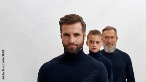 Wide portrait of three generations of Caucasian men