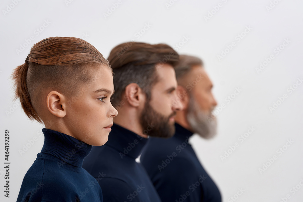 Side view of three generations of men in row Side view of three generations of men in row