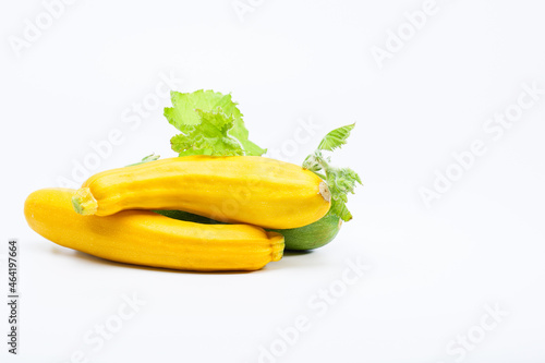 Yellow zucchinis, squash with green leaf on a white background