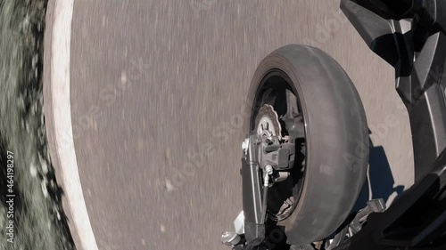 a motorcyle wheel perspective in summer on the road