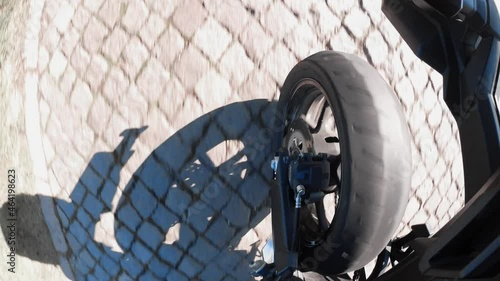 a motorcyle wheel perspective in summer on the road