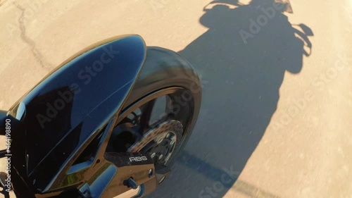 a motorcyle wheel perspective in summer on the road