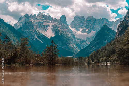 Lake and a Dolomites mountain top in background, South Tyrol, Italy.