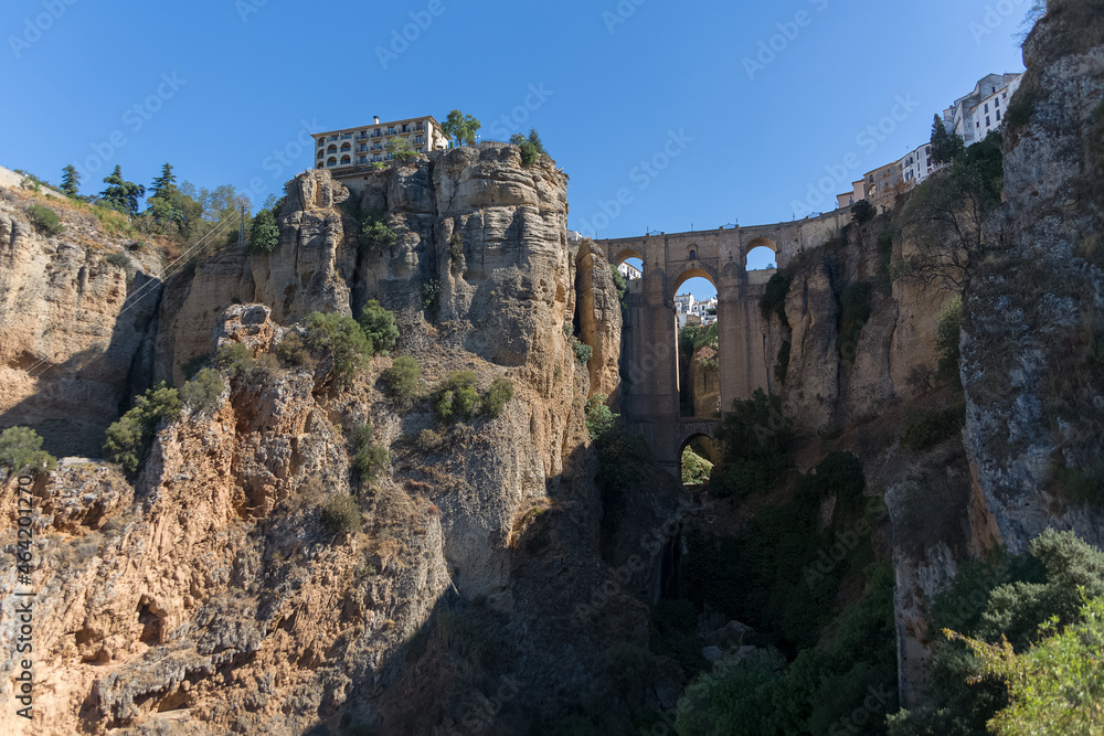 View at the New Bridge above the gauge and the natural geological phenomenon, erosion cliffs around the city, a iconic and touristic travel destination on Ronda city