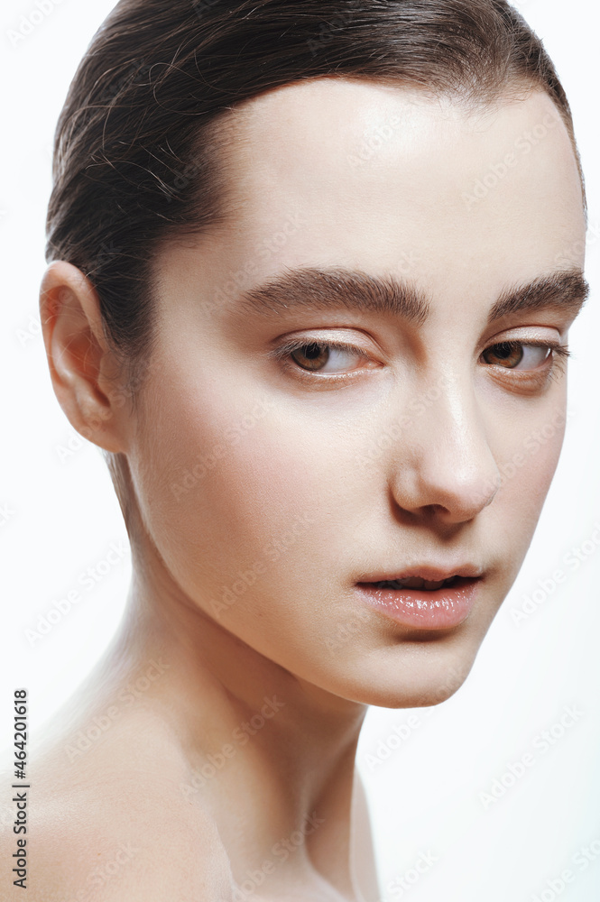 Closeup portrait of beautiful girl with clean shiny healthy skin and nude makeup. Natural skincare beauty. Closeup portrait of beautiful girl with clean shiny healthy skin and nude makeup. Natural skincare beauty.