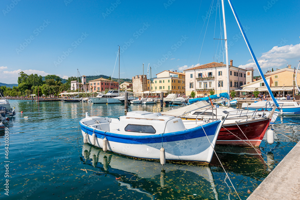 Port of the small village of Bardolino with many boats moored, tourist resort on the coast of Lake Garda (Lago di Garda). Verona province, Veneto, Italy, southern Europe.