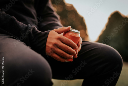 Man sitting and drinking alcohol outdoors