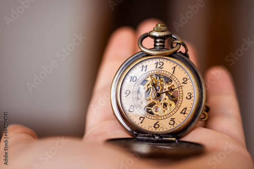 A man holding vintage pocket watch. Time concept.
