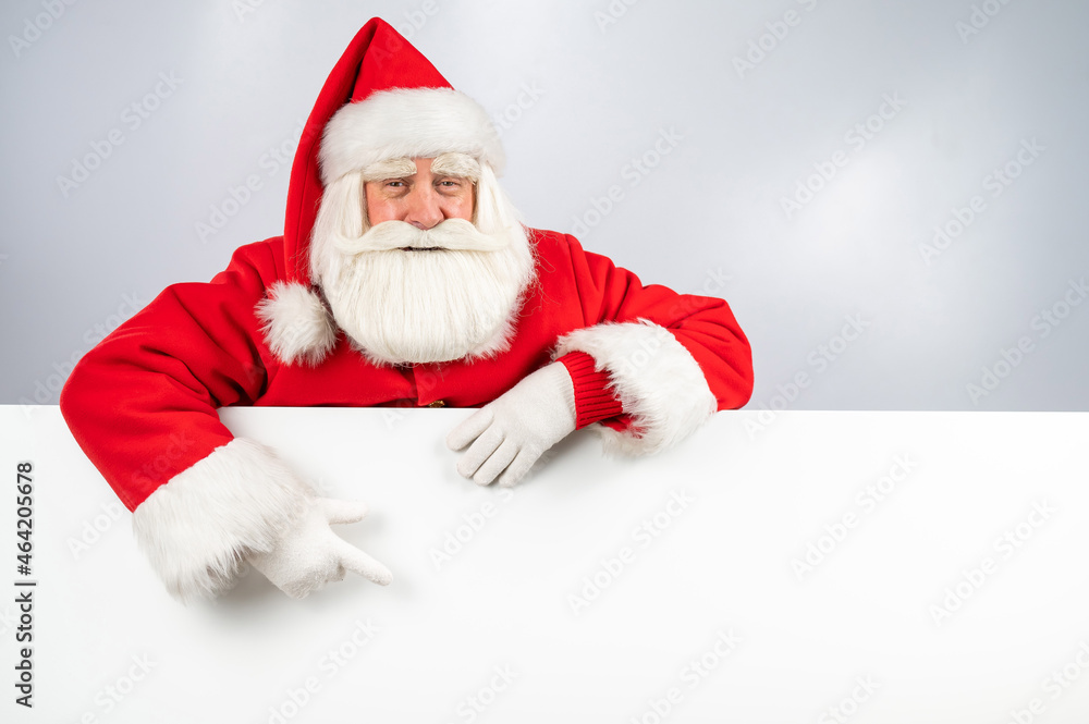 Santa Claus points to white copy space. Advertising. Merry Christmas. Santa Claus points to white copy space. Advertising. Merry Christmas.