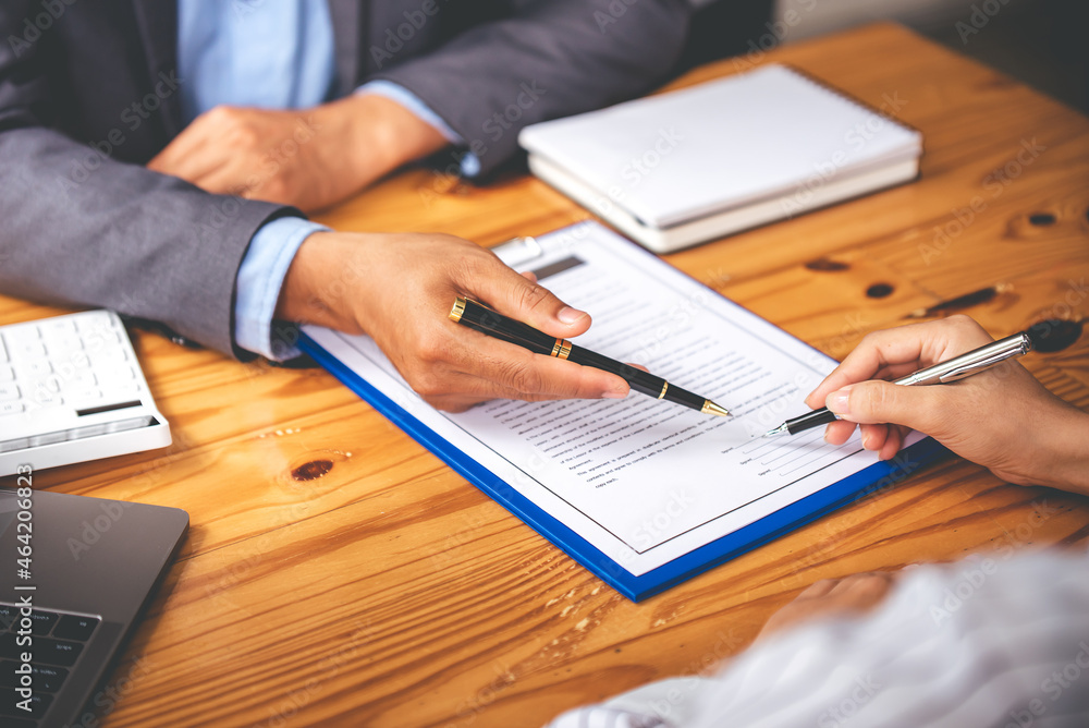 business people negotiating contracts with the documents on the table and sign the contract business people negotiating contracts with the documents on the table and sign the contract