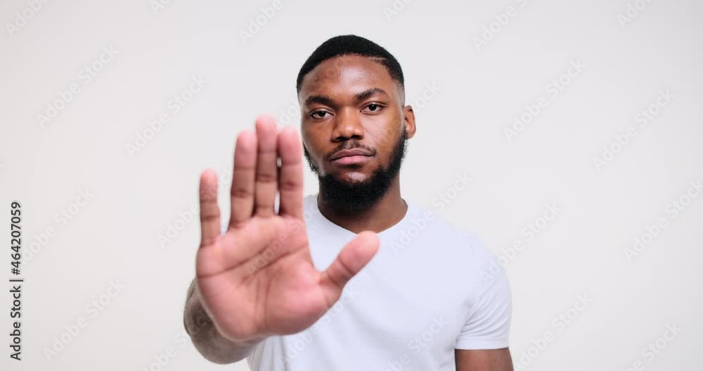 Man saying no with stop hand sign over white background Man saying no with stop hand sign over white background