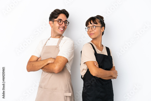 Restaurant mixed race waiters isolated on white background looking over the shoulder with a smile