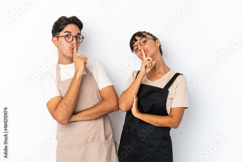 Restaurant mixed race waiters isolated on white background showing a sign of closing mouth and silence gesture