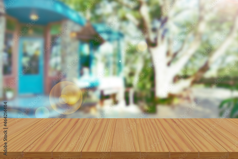 Empty wooden table in front of an abstract blurred background, For product display montage.