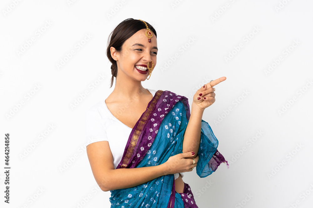 Young indian woman isolated on white background pointing finger to the side and presenting a product Young indian woman isolated on white background pointing finger to the side and presenting a product