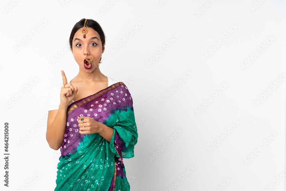 Young indian woman isolated on white background intending to realizes the solution while lifting a finger up Young indian woman isolated on white background intending to realizes the solution while lifting a finger up