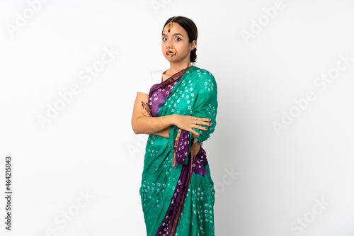Young indian woman isolated on white background making doubts gesture while lifting the shoulders