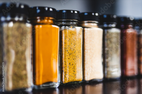 spices seeds and seasonings in mathing spice jars on tidy pantry shelf, simple vegan ingredients and flavoring your dishes photo