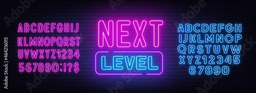 Next level neon sign on brick wall background.