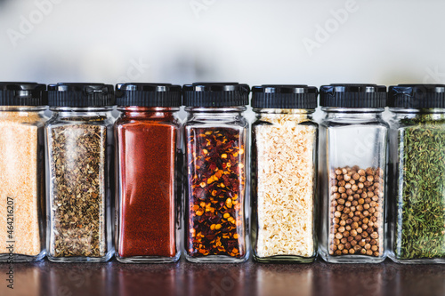 spices seeds and seasonings in mathing spice jars on tidy pantry shelf, simple vegan ingredients and flavoring your dishes