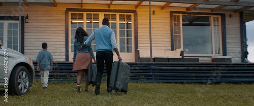WIDE Happy African American family of arriving by car to their new house