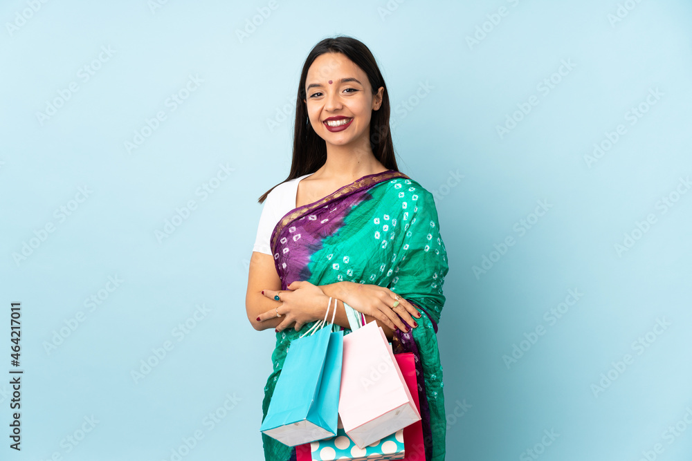 Young Indian woman with shopping bags keeping the arms crossed in frontal position Young Indian woman with shopping bags keeping the arms crossed in frontal position