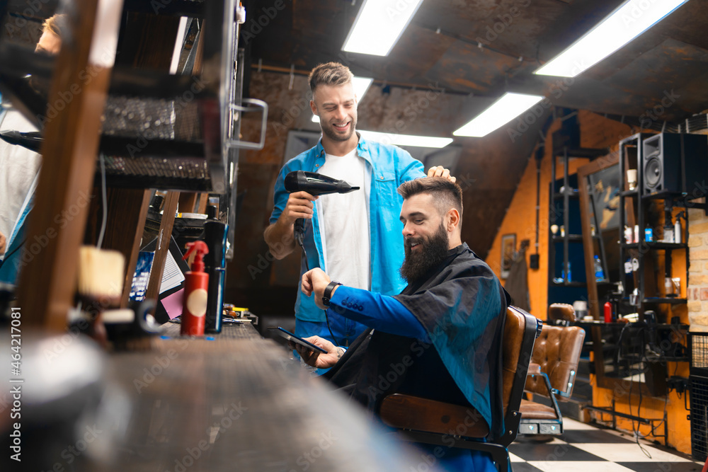 Young bearded businessman at the hairstylist