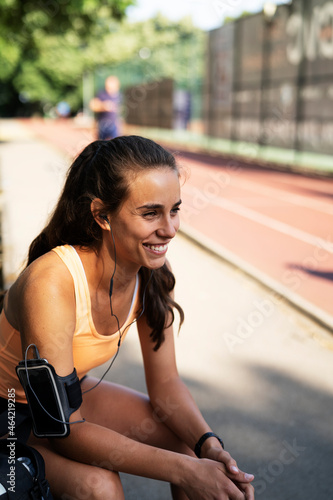 Beautiful athlete woman in sportswear. Young woman pripering for the training outdoors. © JustLife