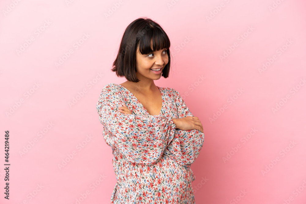 Young pregnant woman over isolated pink background looking to the side Young pregnant woman over isolated pink background looking to the side