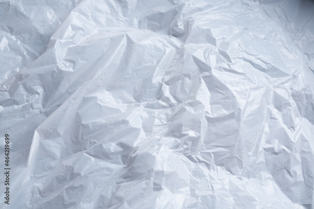 Reflecting light and shadow on creases and folds in scrunched white waxed paper