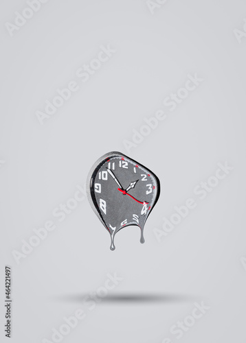 Melting clock on grey background. Time passing by idea. Minimal abstract life or business concept. With copy space.