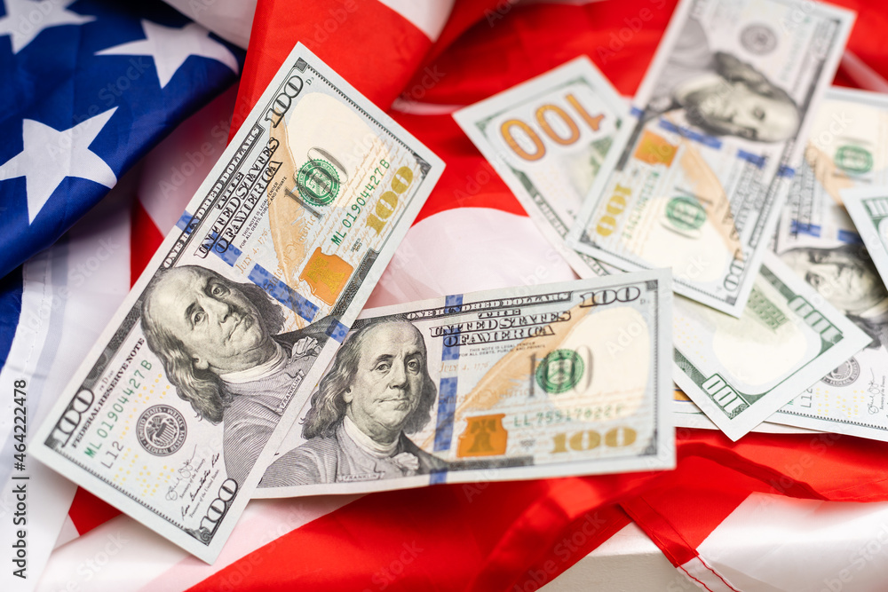 top view american flag on us dollars background top view american flag on us dollars background