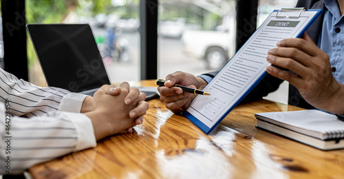 Employees use the calculator to calculate monthly rent for tenants and explain renting details and calculate monthly rent payments to tenants before signing the contract. Renting a house concept. photo