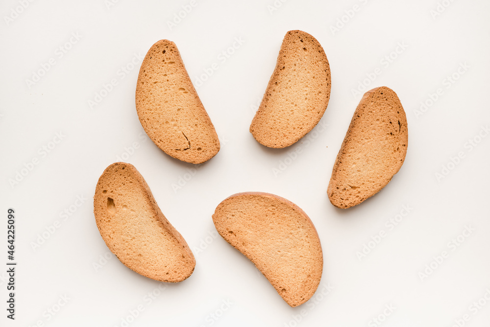 Fototapeta premium Breadcrumbs on a white plate. Rusks on a white background. Vanilla rusks.