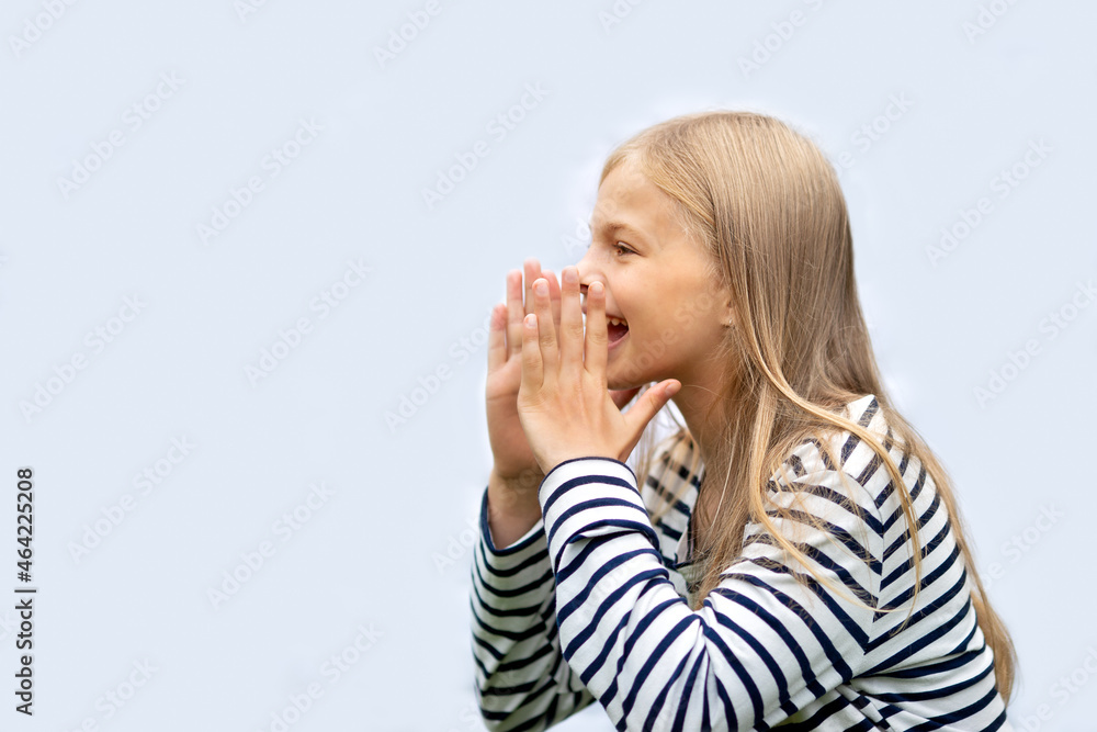 Girl put her hands to her mouth and screams. Isolate on a gray background Girl put her hands to her mouth and screams. Isolate on a gray background
