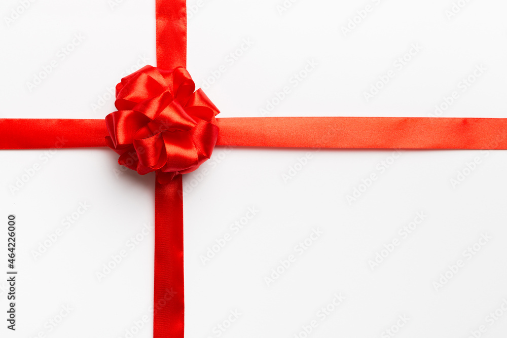 Top view of Red ribbon rolled and red bow isolated on colored background. Flat lay with copy space Top view of Red ribbon rolled and red bow isolated on colored background. Flat lay with copy space