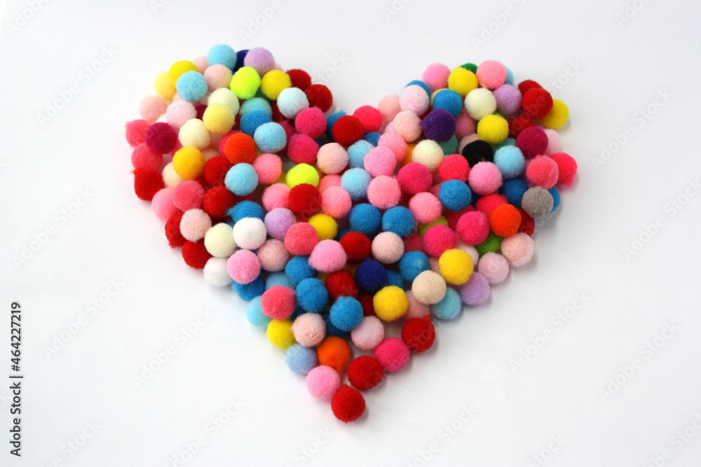 Fluffy pom-poms are in the shape of a heart. Fluffy pom-poms are in the shape of a heart.