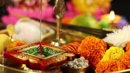 Filling Or Pouring Oil In Square Decorative Clay Diya Deep Or Dia In Brass Thali And Illuminating Flame. Theme For Navratri Pooja, Dussehra Puja, Deepawali Or Shubh Deepavali